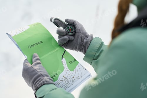 Preview: Young Woman Navigating with Compass and Map during Outdoor Adventure