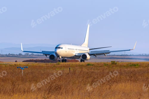 Preview: Passenger plane taking off from runway at airport on sunny day