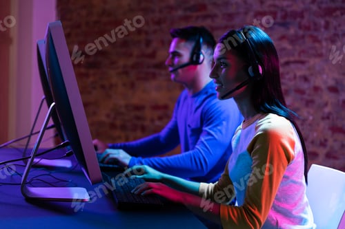 Preview: Caucasian man and a mixed race woman working late in a customer support office