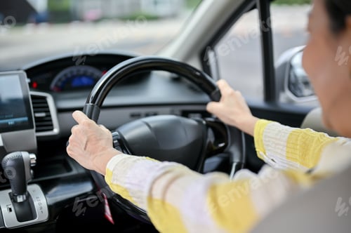 Preview: Close-up image of a happy Asian senior lady driving a car. Transportation, automobile