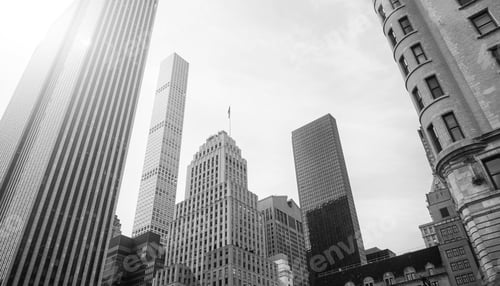 Preview: Looking up at New York City skyscrapers against the sun, USA.