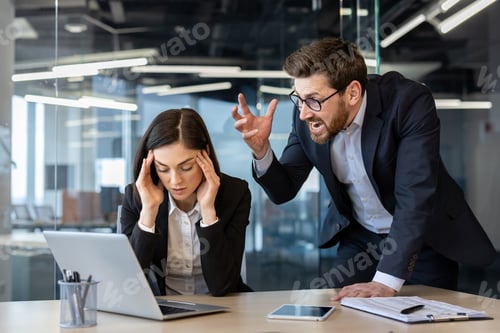 Vista previa: Angry boss shouting at stressed female office worker in modern office setting
