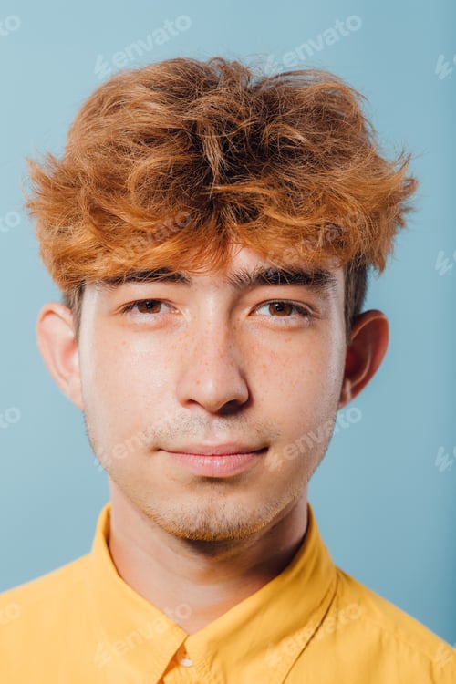 Preview: close up. serious guy in yellow shirt, young man,