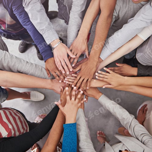 Preview: Cropped shot of a business team standing in a circle with their hands stacked