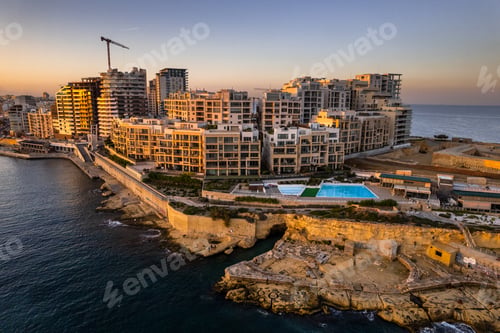 Preview: Skyline of Sliema, Malta at sunset. Blue sea waters and clear sky. Drone aerial view