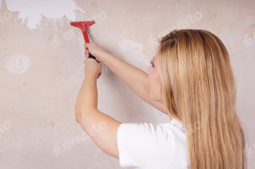 Preview: Woman Removing Wallpaper with a Scraper in Home