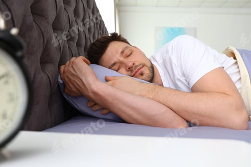 Preview: Handsome man sleeping on pillow at home. Bedtime