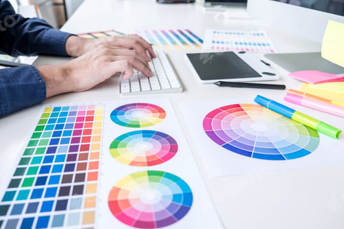 Preview: Male creative graphic designer working on color selection and color swatches