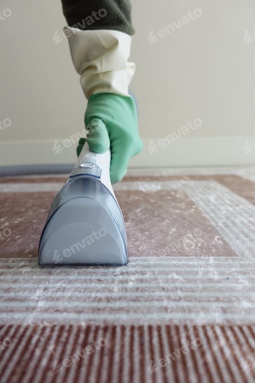 Preview: Cleaning carpet with a steam cleaner in a living room