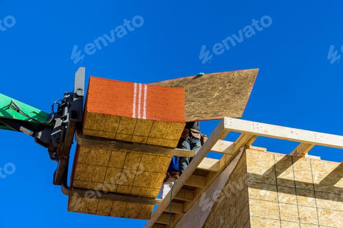 Preview: House under construction worker is covering plywood the wooden with using hydraulic hammer