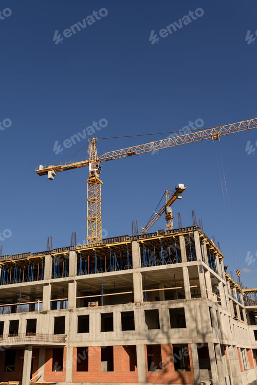 Preview: construction site with crane and building in background. yellow colored crane is in center of stage.
