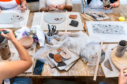 Preview: Ceramic Workshop. Work table. Women working clay to make ceramics. Banner.
