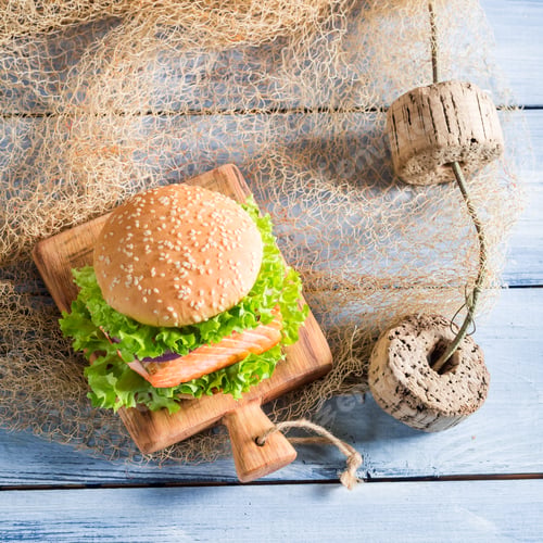 Preview: Homemade burger with fish and vegetables on fishing net