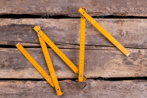 Preview: Yellow folding ruler on wooden boards background