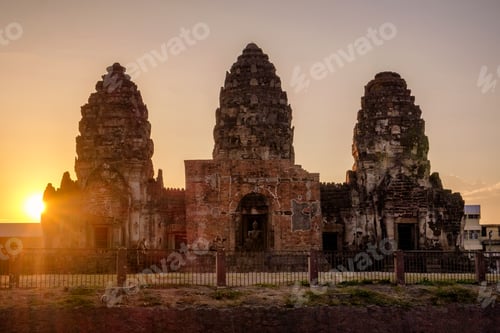 Preview: Sunset over ancient monument (Phra Prang Sam Yot) khmer style with monkey