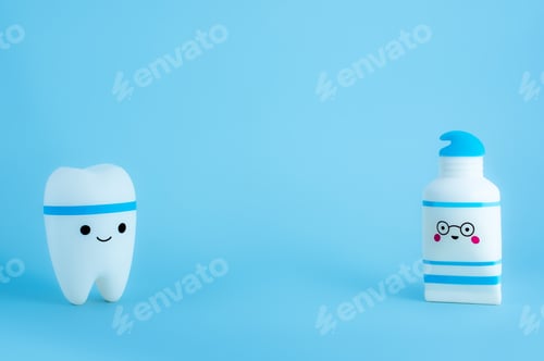 Preview: Smiling tooth and tube of toothpaste toys on blue background.