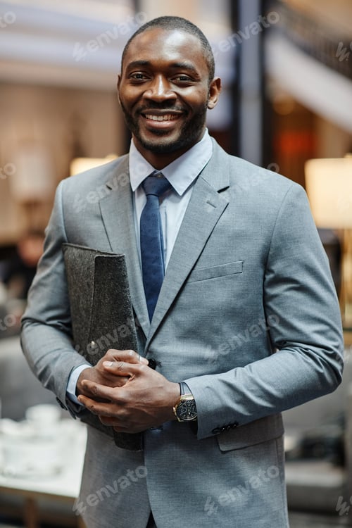 Preview: Smiling Businessman Posing in Lobby
