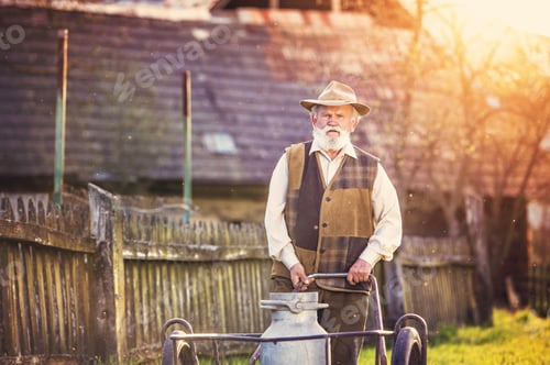 Preview: Senior man with milk kettle