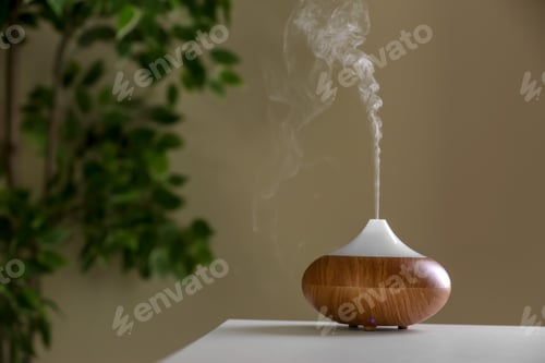 Preview: Aroma oil diffuser lamp on table against blurred background