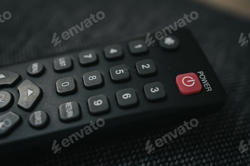Preview: Closeup shot of remote control for TV on the black background
