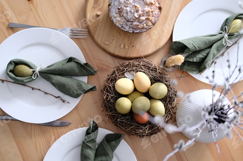 Preview: Top view of beautiful Easter table with pastries, willow branches, eggs and candles.