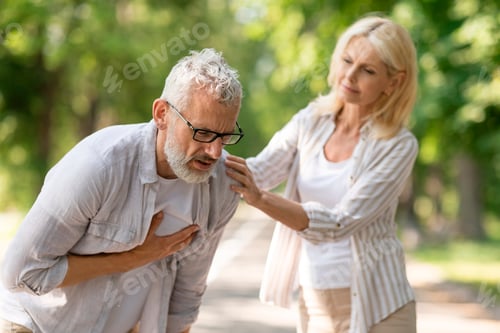 Preview: Senior man suffering from heart attack while walking with wife in park
