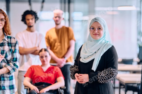 Preview: A diverse group of young business people walking a corridor in the glass-enclosed office of a modern