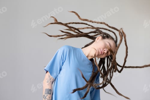 Preview: Tattooed Woman with Long Free Dreadlocks Dancing and Moving on White