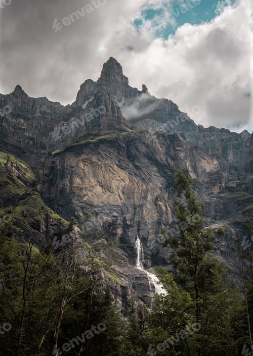 Preview: Vertical shot of a waterfall in Cirque Du Fer A Cheval at Alpes