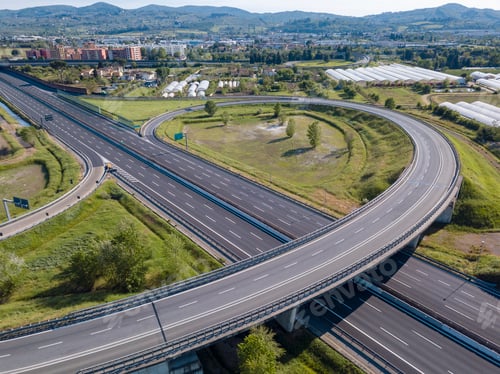 Preview: Aerial view of a highway interchange with lush green surroundings.