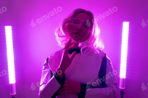 Preview: A woman in a suit and futuristic glasses with pink led lights, virtual concept, metaverse, looking