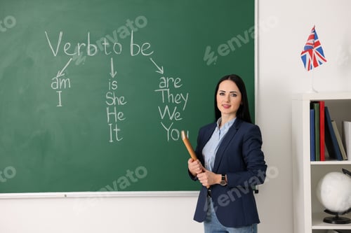 Preview: English teacher during lesson near chalkboard in classroom