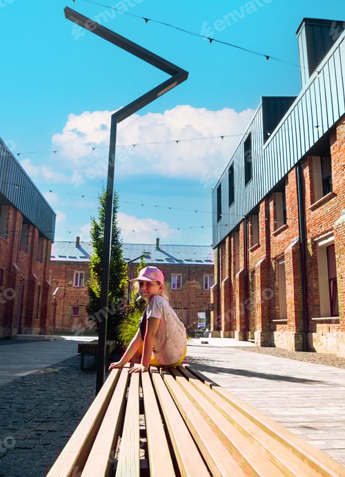 Preview: Child girl rests in modern cafe in loft style Break-out area red brick walls Old building renovation