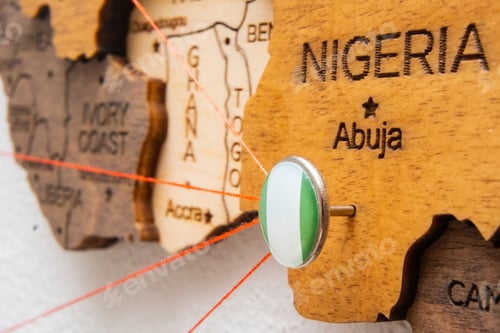 Preview: Nigeria flag on the pin with red thread showed the paths on the wooden map.