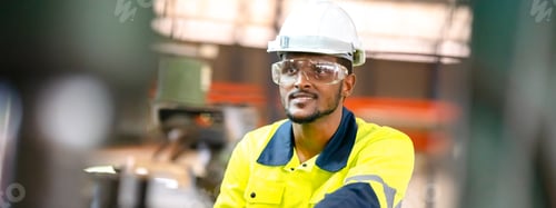 Preview: Production engineers in safety wear are assisting adjusting and maintaining CNC or factory machine