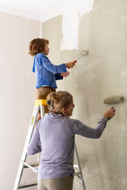 Preview: A woman and an eight year old boy decorating a room, painting walls.