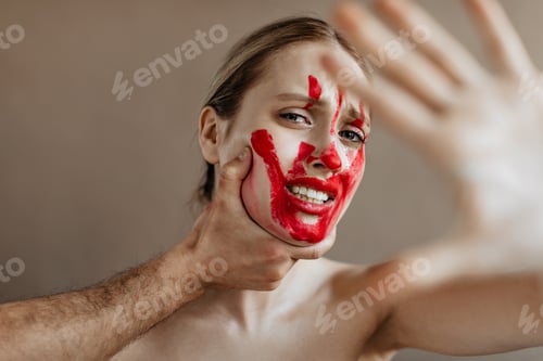 Preview: Portrait of woman with bloody mark on her face, who wants to stop violence