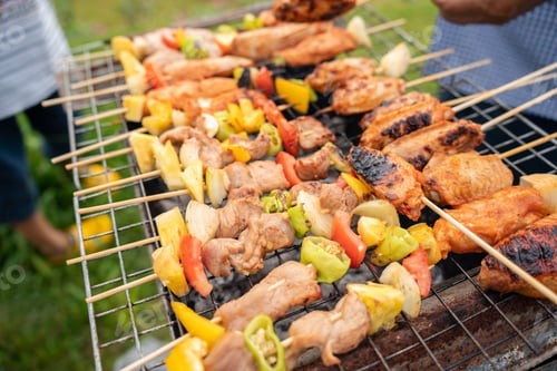 Vista previa: Assorted delicious grilled meat with vegetables on barbecue grill with smoke and flames. Grilling