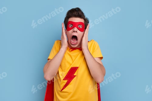 Preview: Astonished Man Wearing a Superhero Costume with a Mask