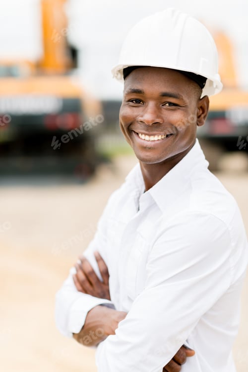 Preview: Architect At A Construction Site Wearing A Helmet And Smiling