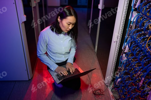 Preview: Concentrated Asian IT engineer connecting to server