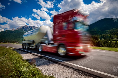 Preview: Fuel truck rushes down the highway in the background the Alps. Truck Car in motion blur.