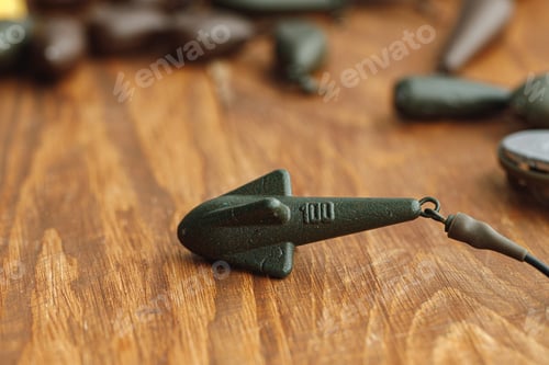 Preview: Heap of lead weights for fishing on wooden background