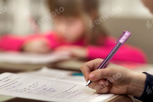 Preview: Portrait of cute pretty little serious child girl drawing with pencil on paper