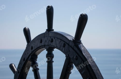 Preview: steering wheel of the ship on the background of the blue sea