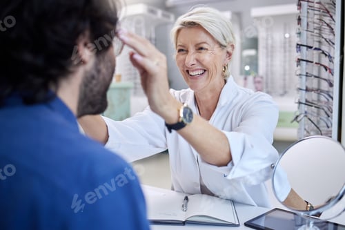 Preview: Optician, happy woman and helping customer with eyes, glasses and vision in store. Face of optometr