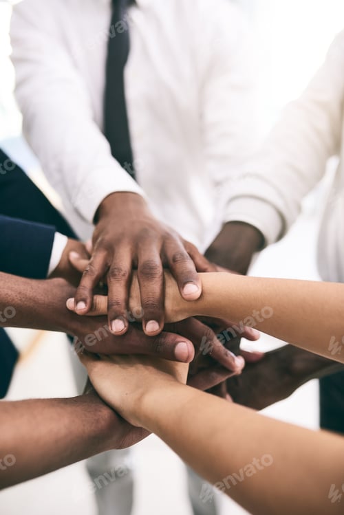Preview: Shot of a motivated group of unrecognizable businesspeoples hands forming a huddle