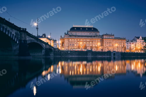Preview: City reflection in Vltava river. Embankment with National Theater at twilight. Prague, Czech