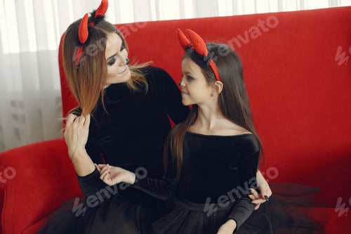 Preview: Mother with daughter in a halloween costume and makeup