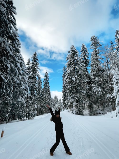 Preview: Woman Enjoying Snowy Winter Day in the Forest
